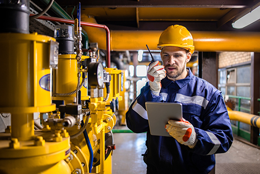 Refinery engineer standing by natural gas pipeline